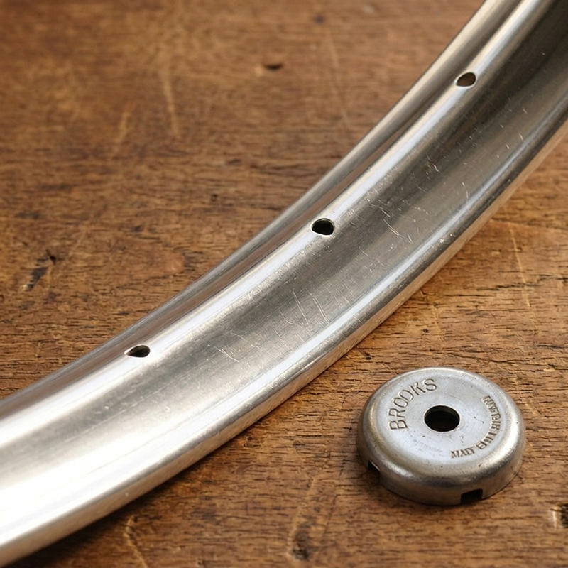 Wheel rim with the Brooks spoke key on the wooden workbench