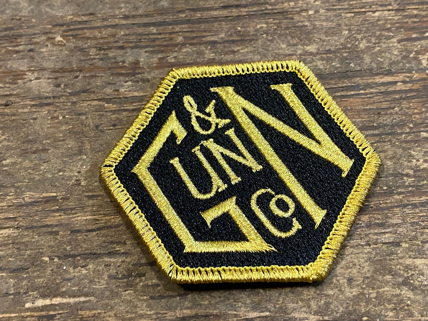 Gunn & Co Gold And Black Embroidered Cloth Badge. Badge