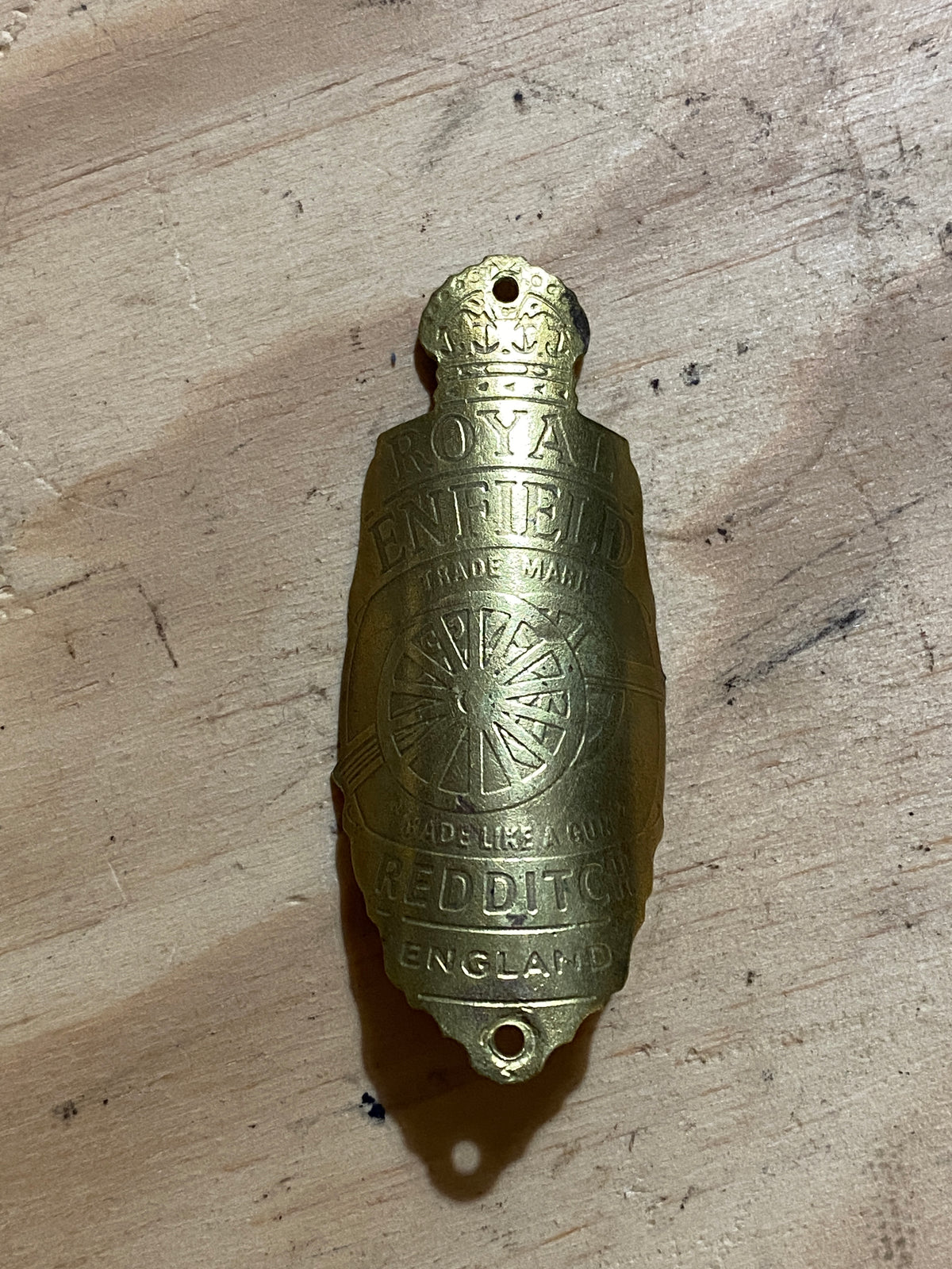 Reverse of Royal Enfield brass bicycle badge, circa 1930s