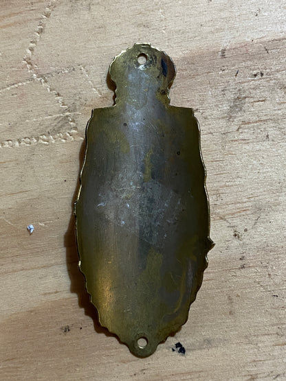 Front of Royal Enfield brass bicycle badge, circa 1930s